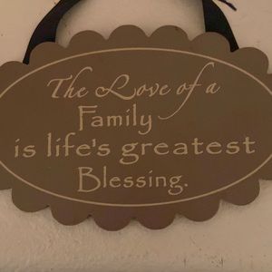 Hanging sign that says: The love of a family is life’s greatest Blessings